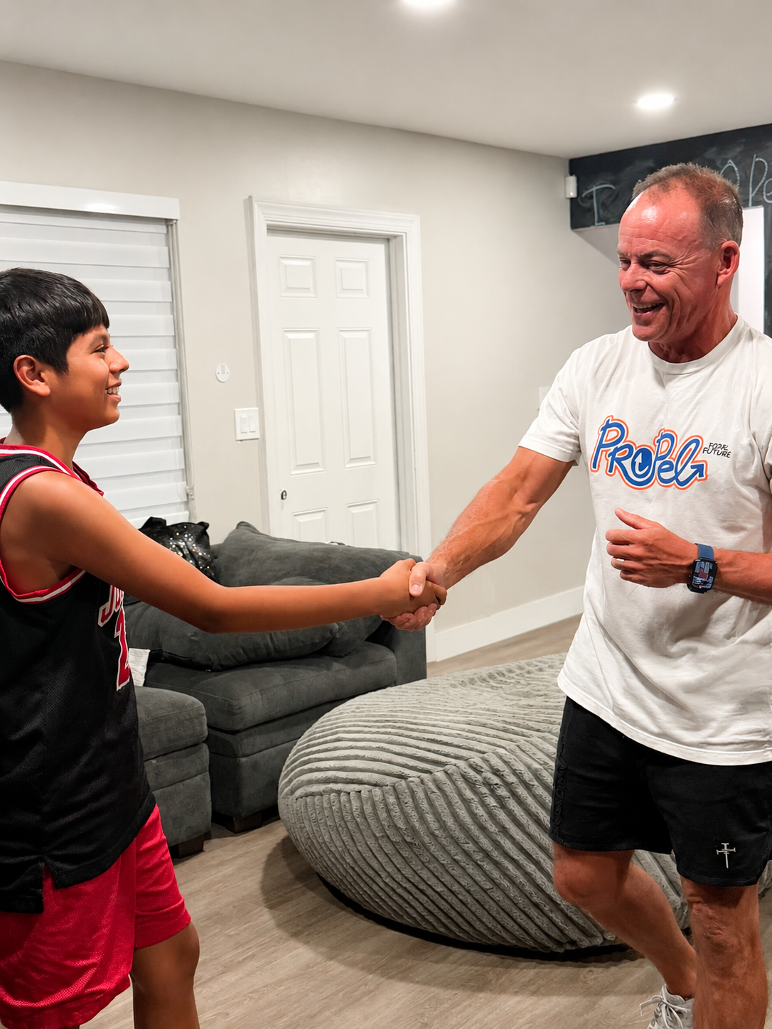 Matthias and Drew sharing a joyful handshake at PROPEL